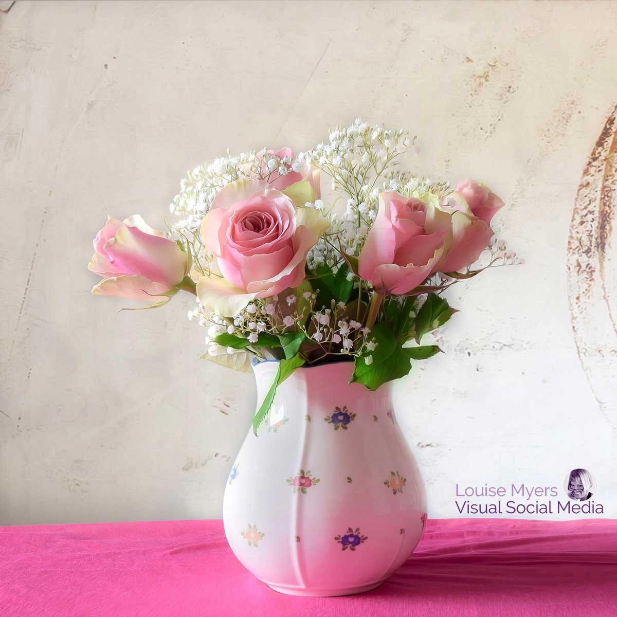 porcelain vase of pink roses.