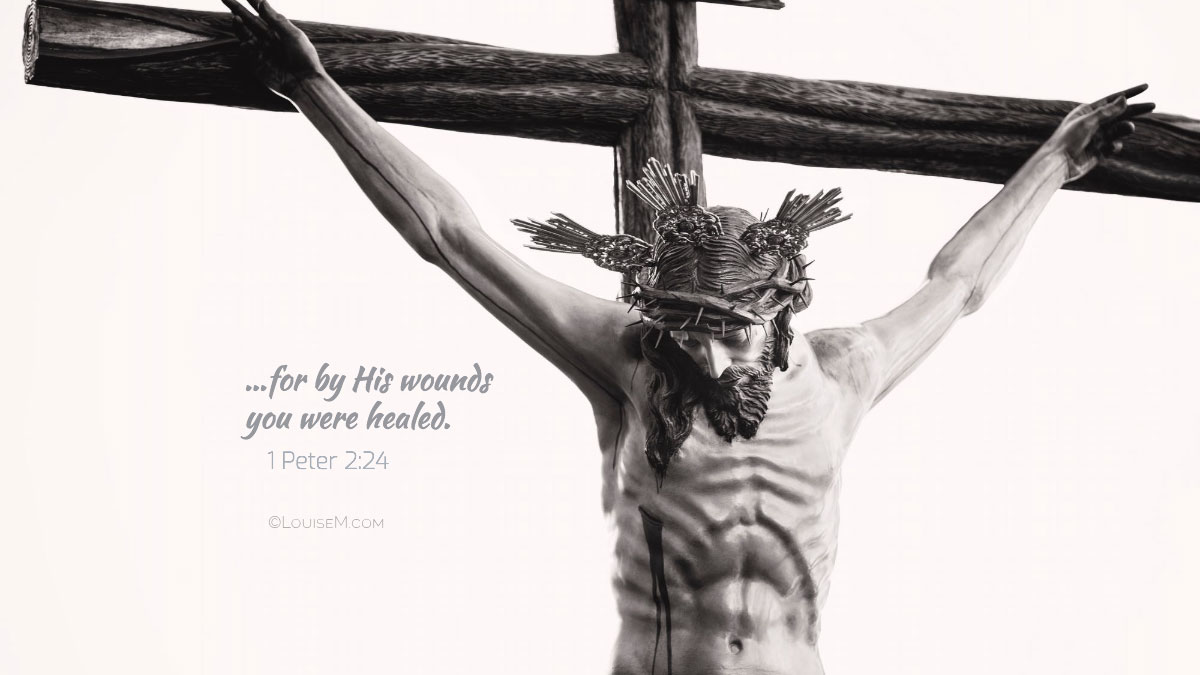 Jesus on crucifix with text, for by his wounds you were healed.