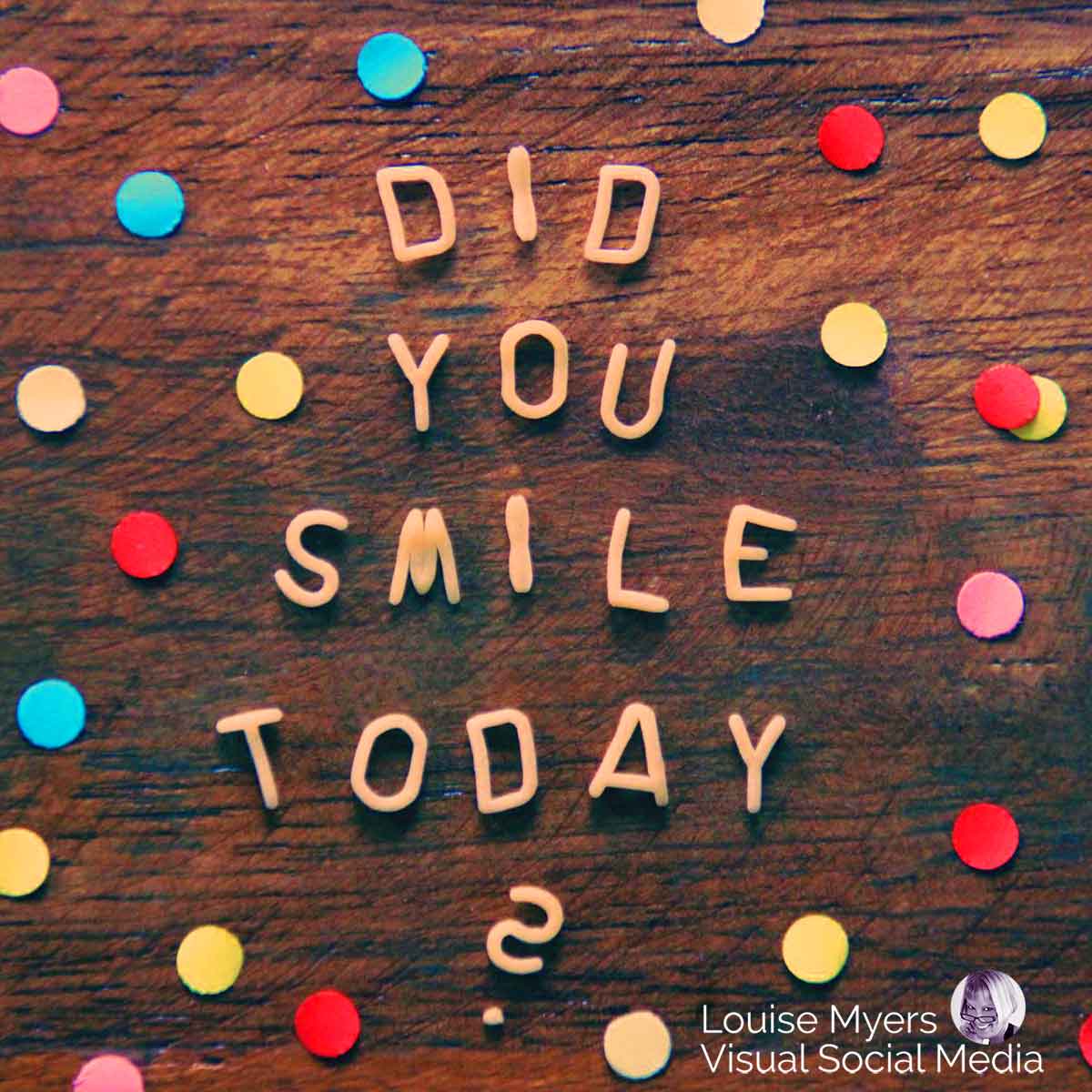 letters spell did you smile today on wood background with colorful dots.