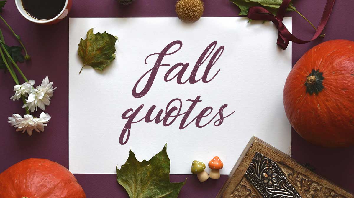 flatlay of pumpkins, autumn leaves and mums on plum-colored table has script saying fall quotes on white page.