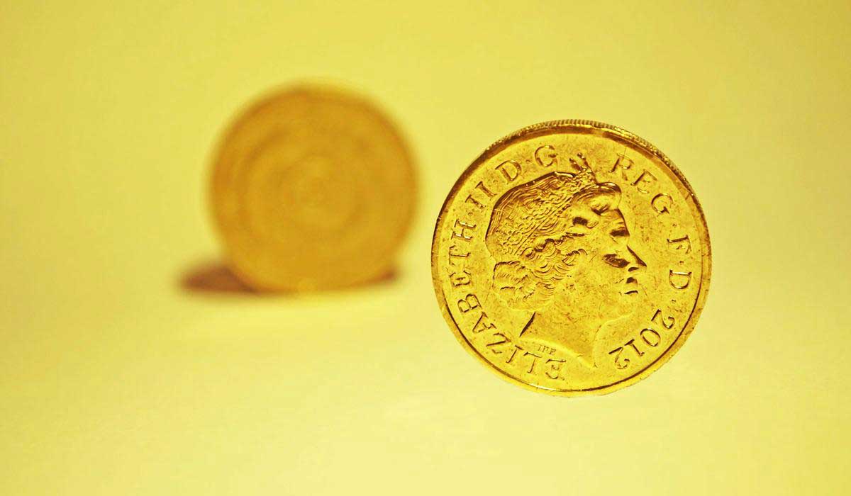 yellow gold coins over a light yellow backdrop.