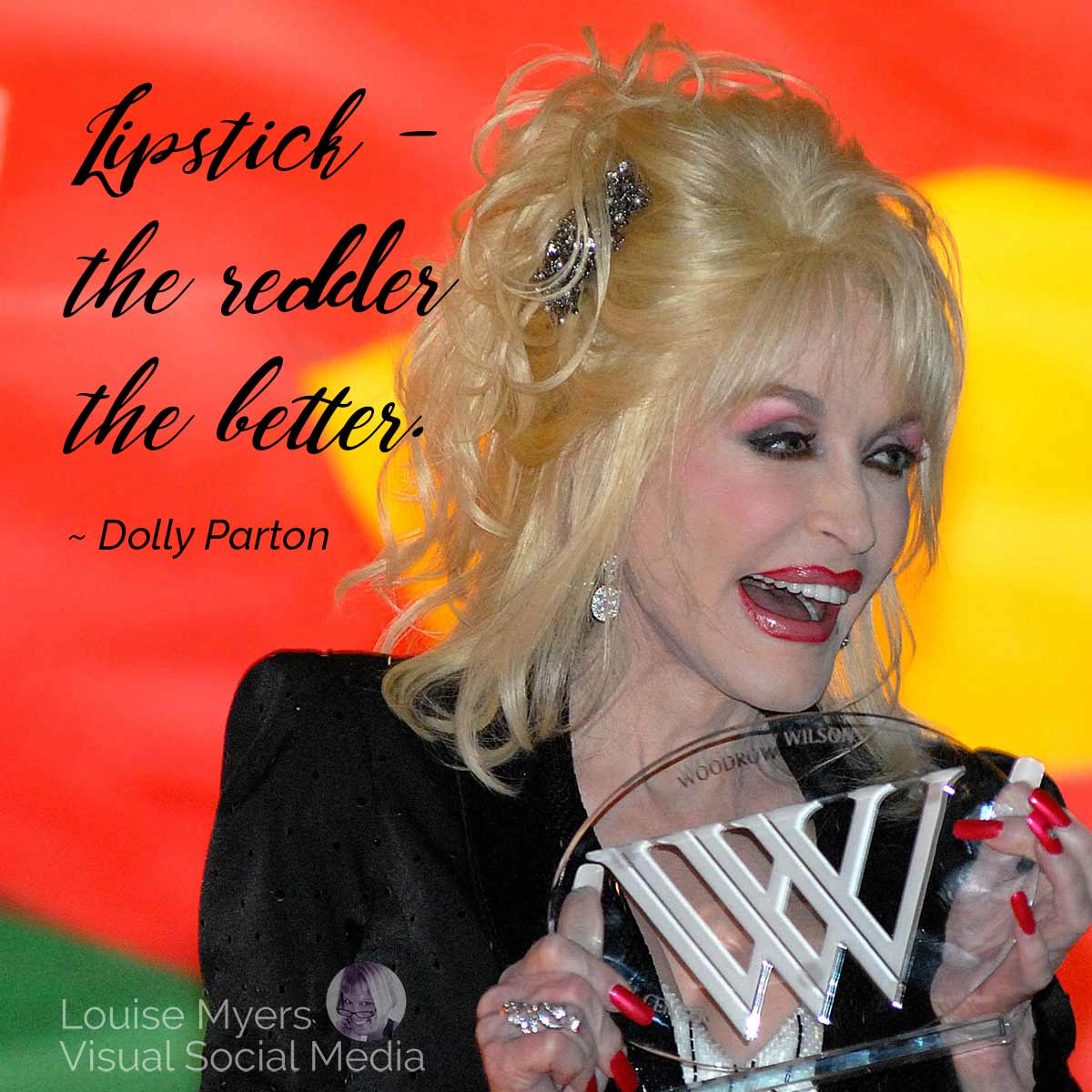 Dolly Parton accepting award has her quote lipstick, the redder the better.