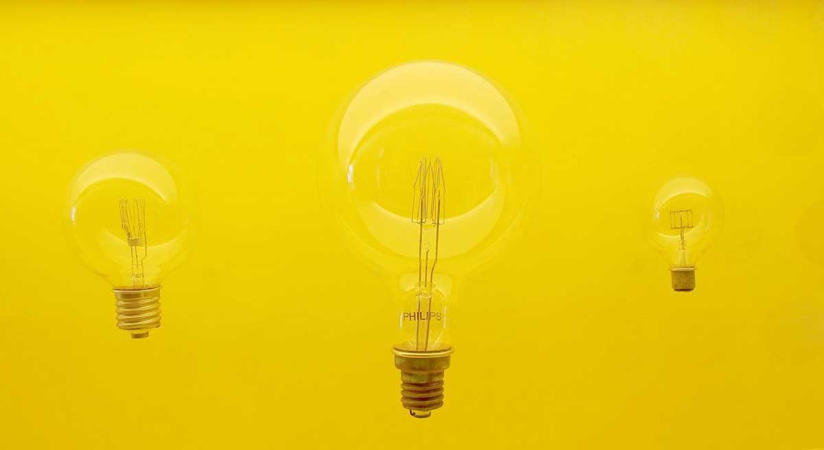 clear round lightbulbs on a bright yellow background.