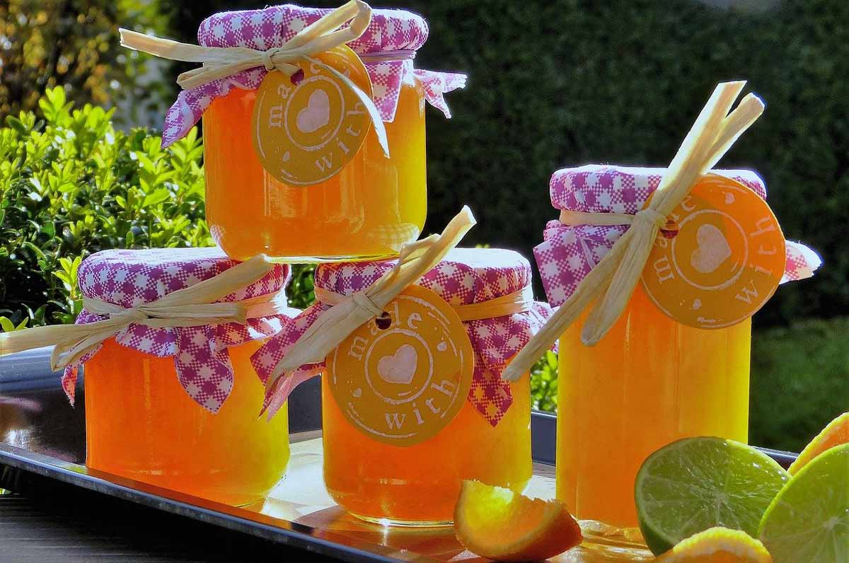 jars of orange jam with checkered tops.