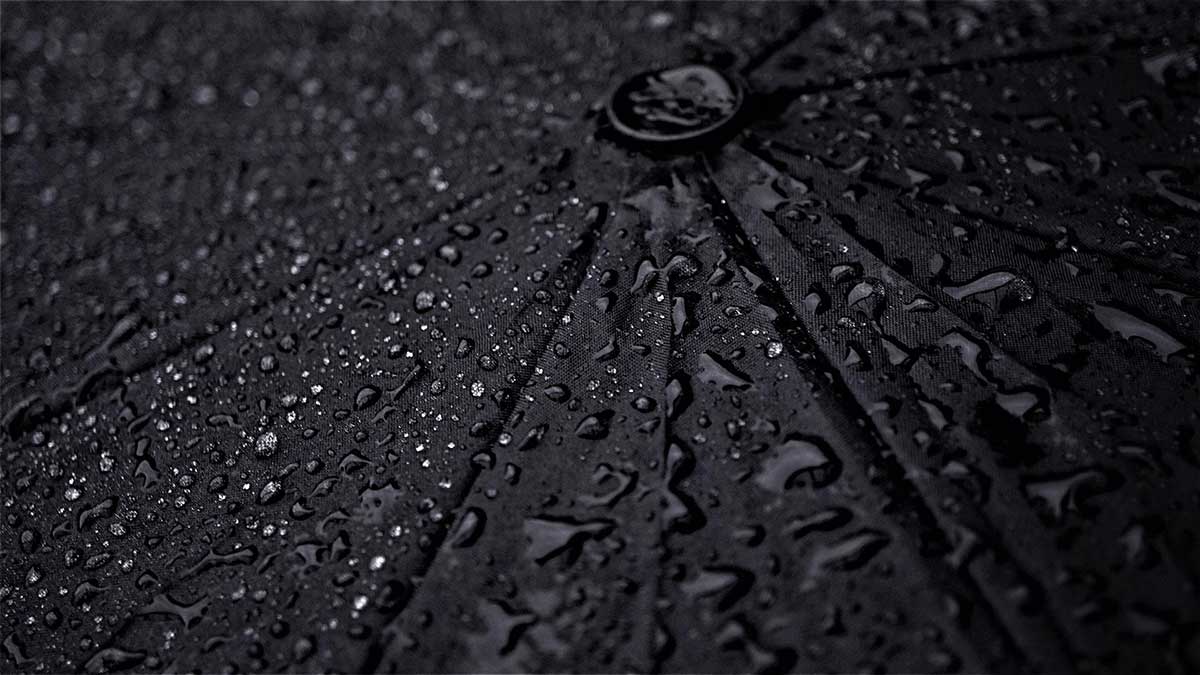 raindrops on black umbrella evoke sadness.