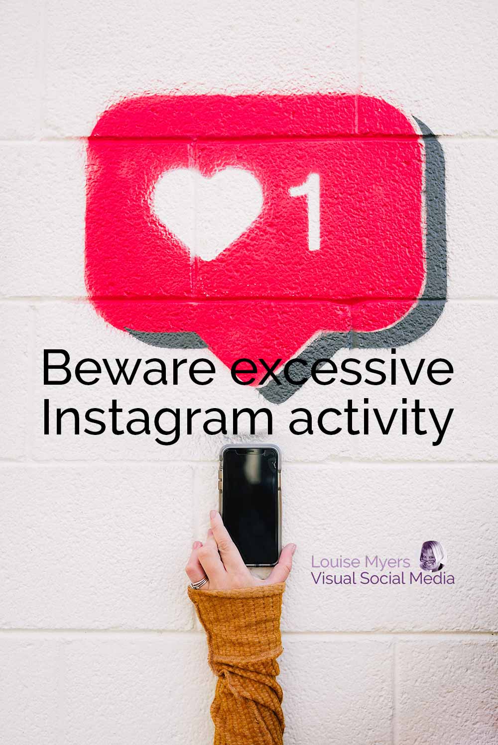 hand holds phone up to instagram like icon on wall with text beware excessive activity.